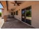 A covered outdoor patio with a ceiling fan and sliding glass doors at 595 W Dragon Tree Ave, Queen Creek, AZ 85140