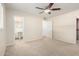 Comfortable carpeted bedroom featuring a ceiling fan and an ensuite bathroom at 606 W 15Th St, Tempe, AZ 85281