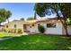 Inviting home showcasing a lush green lawn and mature shade trees, creating a serene outdoor space at 606 W 15Th St, Tempe, AZ 85281