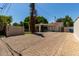 Charming home with brick-paved driveway, gated yard, mature trees, and a covered front porch at 606 W 15Th St, Tempe, AZ 85281