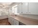 Cozy kitchen features white cabinetry, tiled floor, and a bright window over the sink at 606 W 15Th St, Tempe, AZ 85281