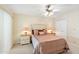 Inviting bedroom with plush carpet, ceiling fan, lamps, and a comfortable bed setup at 636 S Rosemont --, Mesa, AZ 85206