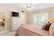 Comfortable bedroom with a soft carpet, light walls, ceiling fan and access to patio at 636 S Rosemont --, Mesa, AZ 85206