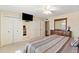 Comfortable bedroom with a queen bed, ceiling fan, closet, and a dresser with large mirror at 636 S Rosemont --, Mesa, AZ 85206
