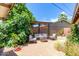 Lush backyard oasis featuring a cozy lounge area with a fire pit and colorful flowers at 6749 E Lewis Ave, Scottsdale, AZ 85257