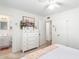 Well-lit bedroom featuring a dresser and convenient access to the bathroom, offering a practical layout at 6749 E Lewis Ave, Scottsdale, AZ 85257