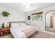 Bright bedroom featuring a cozy bed, modern decor, and ample natural light from the window at 6749 E Lewis Ave, Scottsdale, AZ 85257