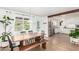 Bright dining room with a wood table and bench seating, and views of the serene backyard at 6749 E Lewis Ave, Scottsdale, AZ 85257