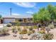Charming single-story home featuring a desert landscape, flowering plants, and an eye-catching exterior at 6749 E Lewis Ave, Scottsdale, AZ 85257