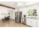 Bright kitchen featuring stainless steel appliances, white cabinetry, granite counters and an attached dining room at 6749 E Lewis Ave, Scottsdale, AZ 85257