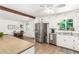 Bright kitchen with stainless steel appliances, white cabinetry, granite counters and an attached dining room at 6749 E Lewis Ave, Scottsdale, AZ 85257