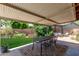 Covered patio with an outdoor dining set that sits off a large, well-maintained lawn at 6749 E Lewis Ave, Scottsdale, AZ 85257