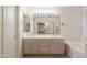 Bathroom featuring double sink vanity with a large mirror and wood cabinets at 7345 E Forge Ave, Mesa, AZ 85208