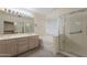 Bright bathroom showcasing double sink vanity, tub, and glass enclosed shower at 7345 E Forge Ave, Mesa, AZ 85208