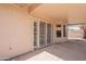 View of the covered patio with sliding glass doors leading to the house at 7345 E Forge Ave, Mesa, AZ 85208