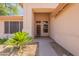 Close up view of home's entryway with security door and well manicured landscaping at 7345 E Forge Ave, Mesa, AZ 85208