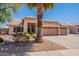 Well-kept single-story home with a three-car garage and desert landscaping at 7345 E Forge Ave, Mesa, AZ 85208