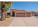 Inviting single-story home with a three-car garage and well-maintained desert landscaping at 7345 E Forge Ave, Mesa, AZ 85208