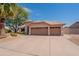 Single-story home with three-car garage, desert landscaping, and a private entryway at 7345 E Forge Ave, Mesa, AZ 85208