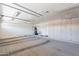 Garage offering plenty of storage with custom installed cabinets, utility sink, and ample lighting at 7345 E Forge Ave, Mesa, AZ 85208