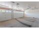 Spacious garage with dual doors, carpeted flooring, and great lighting at 7345 E Forge Ave, Mesa, AZ 85208
