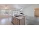 Bright kitchen features an island sink, dishwasher, and light-colored cabinetry at 7345 E Forge Ave, Mesa, AZ 85208