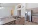 Bright kitchen with bar seating and stainless steel appliances, open to living space at 7345 E Forge Ave, Mesa, AZ 85208