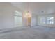 Open living room area featuring a chandelier and large windows at 7345 E Forge Ave, Mesa, AZ 85208
