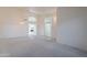 Open-concept living room with neutral carpet and arched doorways for seamless flow at 7345 E Forge Ave, Mesa, AZ 85208