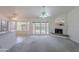 Living room with view of breakfast bar, fireplace, and patio access, offering a bright and airy space at 7345 E Forge Ave, Mesa, AZ 85208