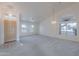 Bright, open-concept living room featuring soaring ceilings and updated flooring at 7345 E Forge Ave, Mesa, AZ 85208