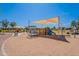 Community playground featuring slides, climbing structures, and shade canopies at 7345 E Forge Ave, Mesa, AZ 85208