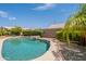 Backyard pool with a waterfall feature surrounded by lush landscaping at 7345 E Forge Ave, Mesa, AZ 85208