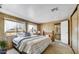 Bedroom featuring a comfortable bed, ample natural light, and en-suite bathroom creating a private retreat at 7711 E Farmdale Ave, Mesa, AZ 85208