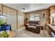 Cozy bedroom with comfortable seating area and a closet for personal storage at 7711 E Farmdale Ave, Mesa, AZ 85208