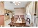 Dining area with a wood table, decorative wallpaper, and window creating a warm and inviting space at 7711 E Farmdale Ave, Mesa, AZ 85208