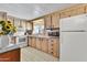 Functional kitchen with essential appliances and cabinetry, adjacent to a cozy dining space at 7711 E Farmdale Ave, Mesa, AZ 85208