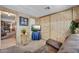 Cozy living room with wood-look walls, mounted tv and comfortable seating at 7711 E Farmdale Ave, Mesa, AZ 85208