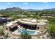Aerial view of a luxurious desert home with a private pool, spa, and a spacious patio at 7731 E Soaring Eagle Way, Scottsdale, AZ 85266