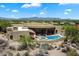 Aerial view of Southwestern-style home with a private pool, spa, and expansive desert views at 7731 E Soaring Eagle Way, Scottsdale, AZ 85266