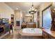 Bright bathroom featuring a jacuzzi bathtub with a chandelier, and lots of cabinet space at 7731 E Soaring Eagle Way, Scottsdale, AZ 85266