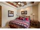 Warm bedroom with exposed wood beam ceilings and Southwestern-style bedding at 7731 E Soaring Eagle Way, Scottsdale, AZ 85266