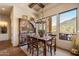 The dining room features a wooden table and chairs set, a hutch, and a large window with views at 7731 E Soaring Eagle Way, Scottsdale, AZ 85266