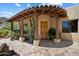 Charming home entrance with a decorative door and lush desert landscaping at 7731 E Soaring Eagle Way, Scottsdale, AZ 85266