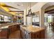 A kitchen island, stainless steel appliances, and an open floor plan are showcased in the kitchen at 7731 E Soaring Eagle Way, Scottsdale, AZ 85266