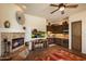 Cozy kitchen with dark wood cabinets, a dining table and a fireplace at 7731 E Soaring Eagle Way, Scottsdale, AZ 85266