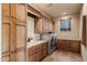 Spacious laundry room with wood cabinets, sink, and modern washer and dryer at 7731 E Soaring Eagle Way, Scottsdale, AZ 85266