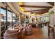 Open-concept living room featuring fireplace, beamed ceilings and access to outdoor patio at 7731 E Soaring Eagle Way, Scottsdale, AZ 85266