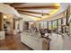 Open-concept living room features a stone fireplace, beamed ceilings, and tile floors at 7731 E Soaring Eagle Way, Scottsdale, AZ 85266