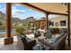 Covered patio with seating area, with a pool and desert landscape in the background at 7731 E Soaring Eagle Way, Scottsdale, AZ 85266
